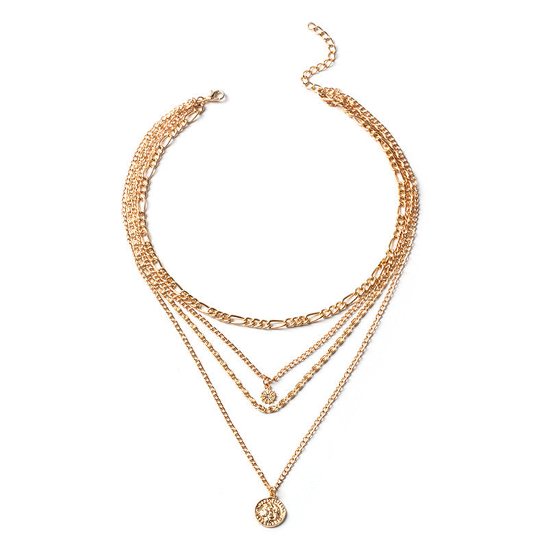 Elegant layered gold necklace with multiple chains and pendant detailing. | Athela